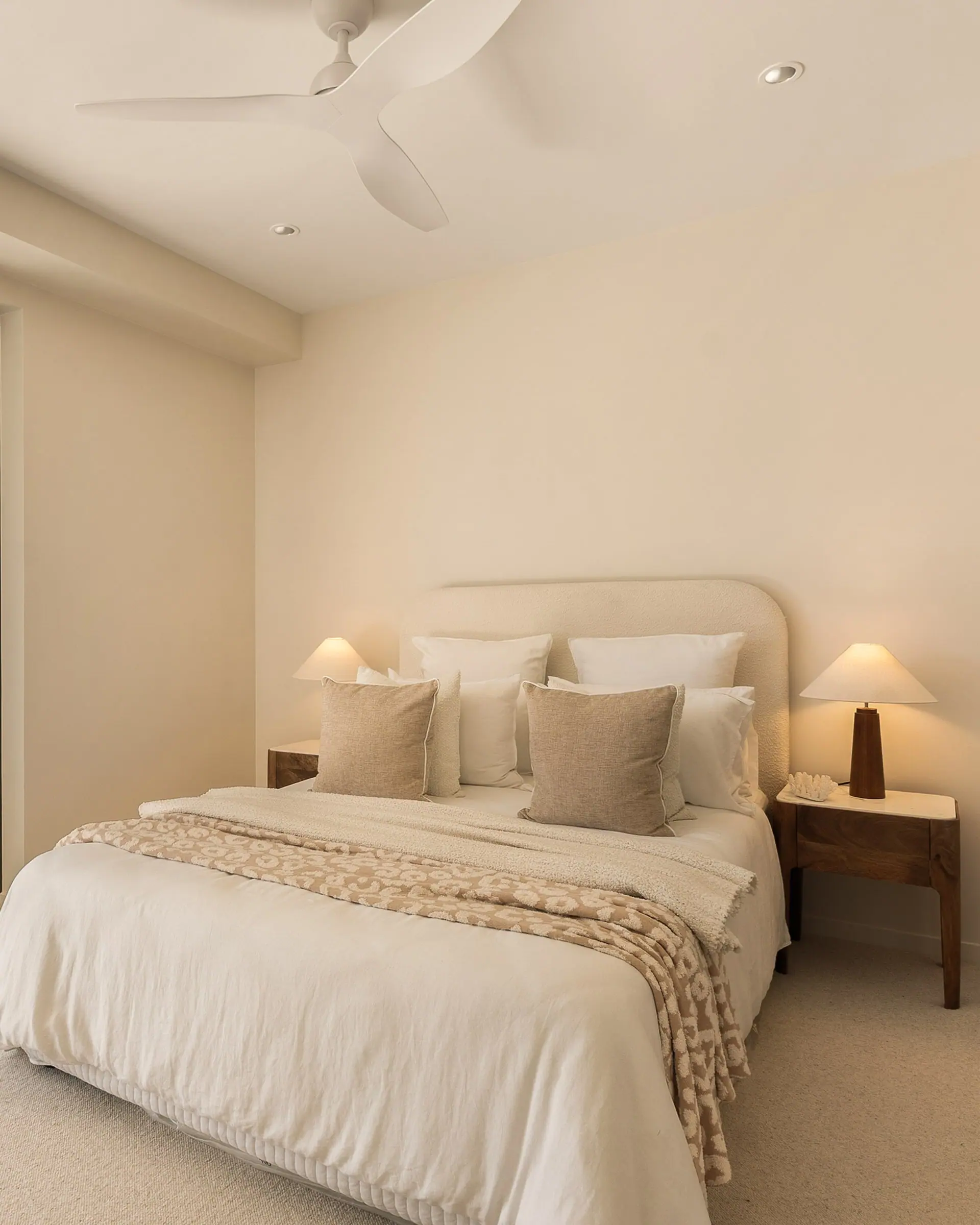 Main bedroom with sliding doors to the balcony and the parkland beyond