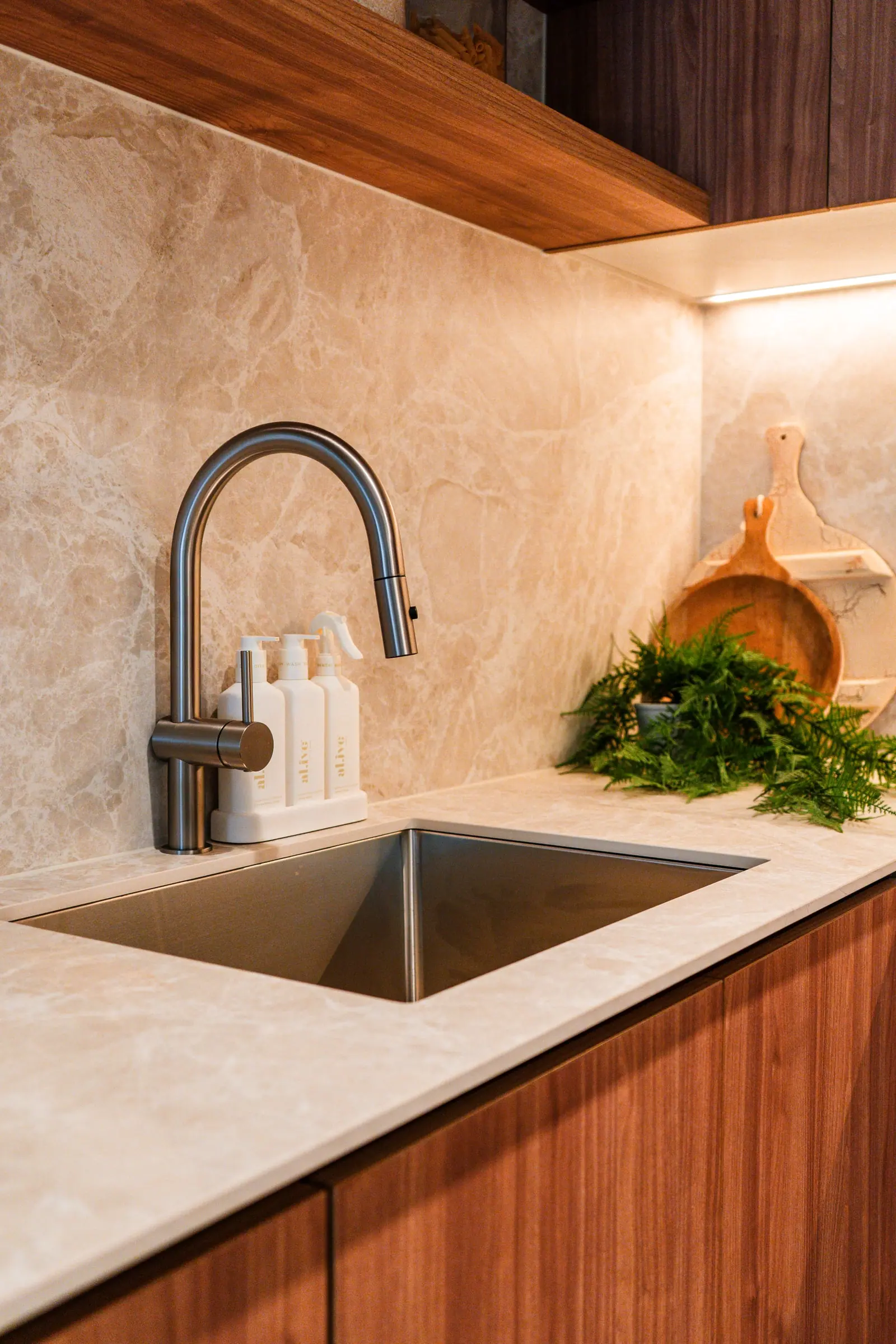 Stone splashback and benchtop by the kitchen sink
