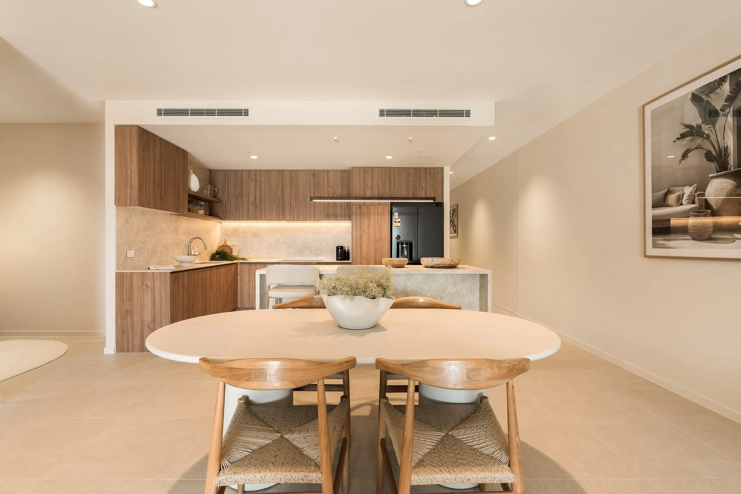 Dining table in front of the open-plan kitchen