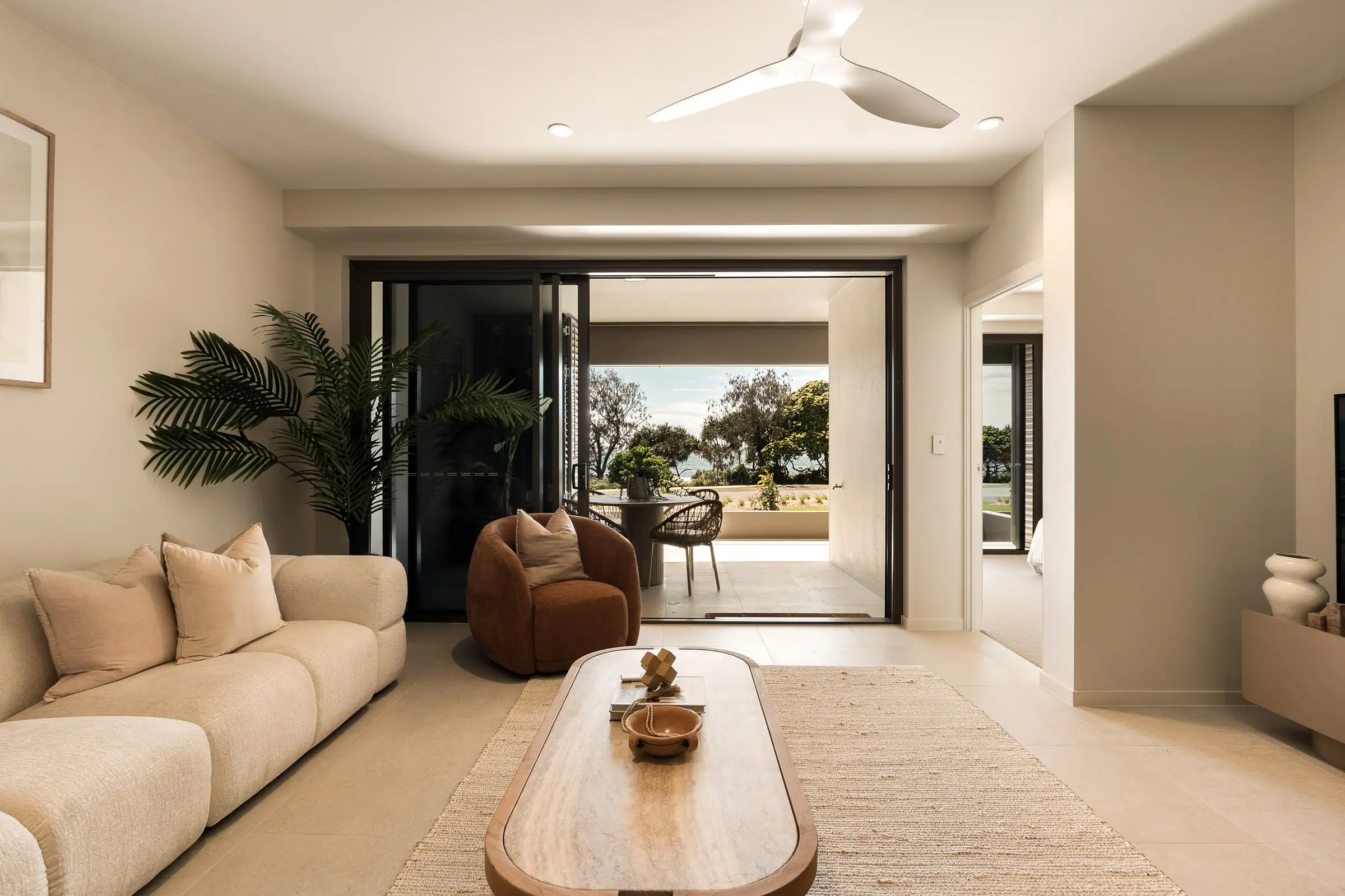 Living room opening through sliding doors to the balcony and the Esplanade parkland